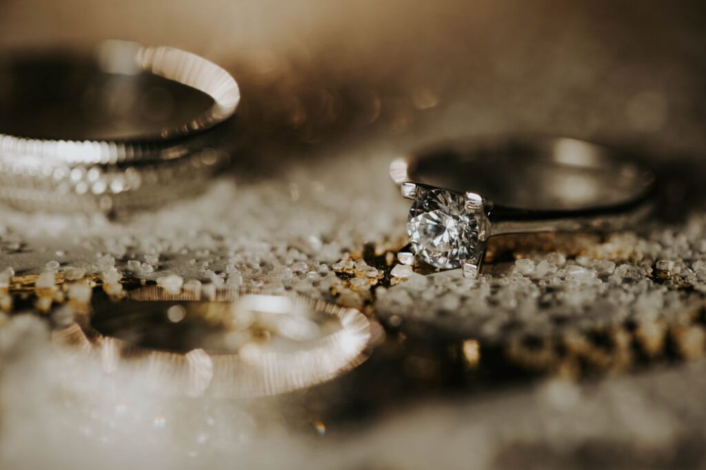 Solitaire engagement ring resting between other rings